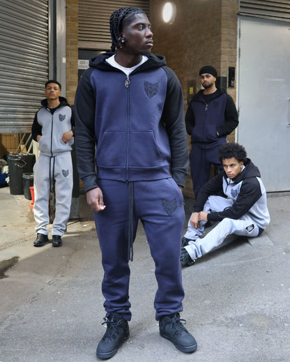 Full-length model wearing the SCREWLOOSE navy and black colour-block hoodie and joggers